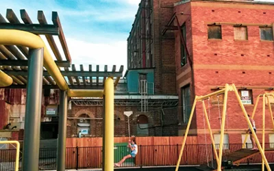 Harts Mill Project: playground equipment in front of a building